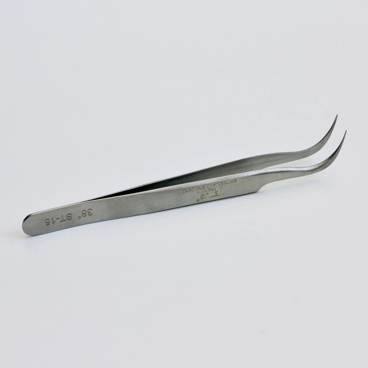 Curved tip stainless steel precision tweezers on white background
