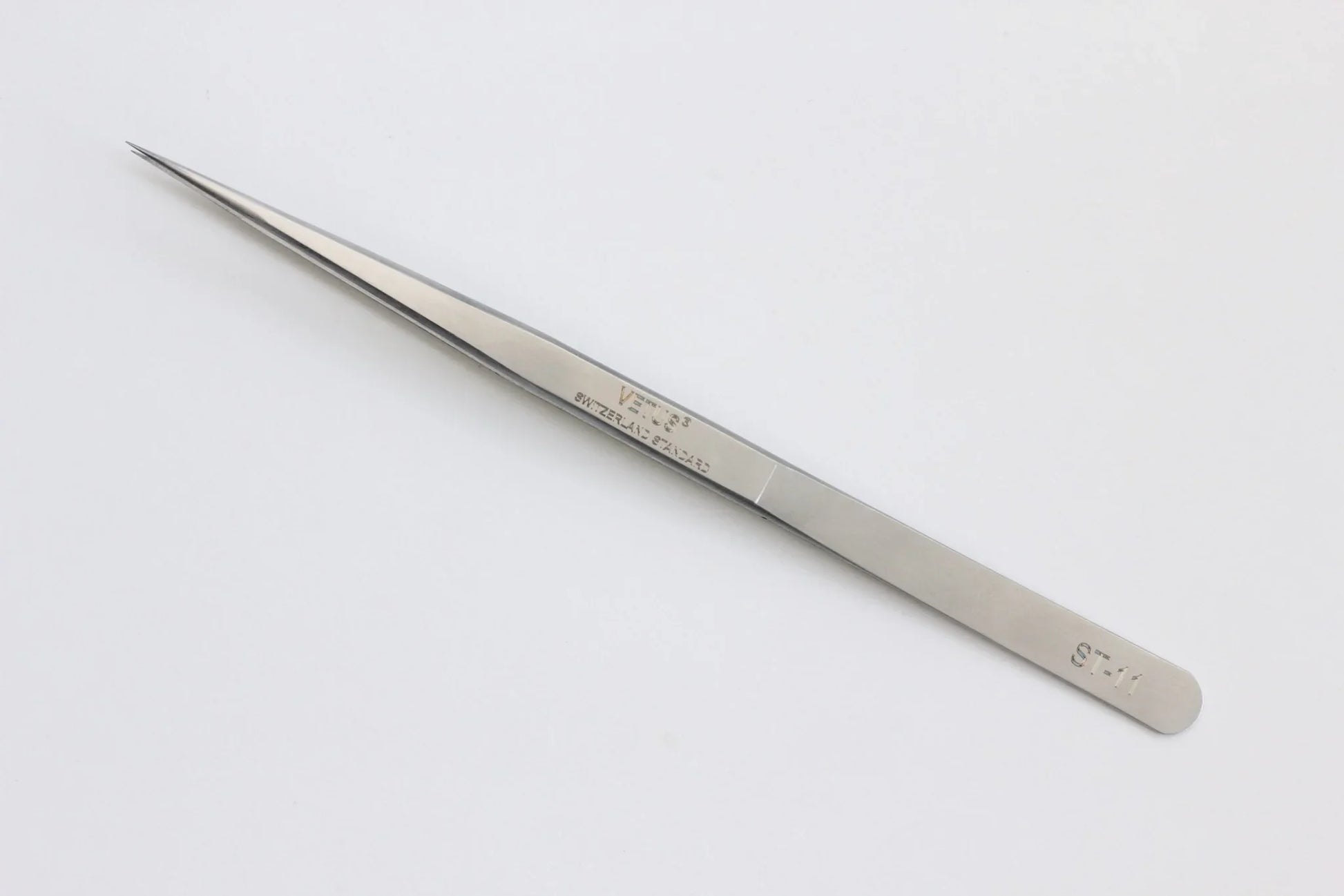 Precision stainless steel fine-tip tweezers on a white background, labeled ST-11